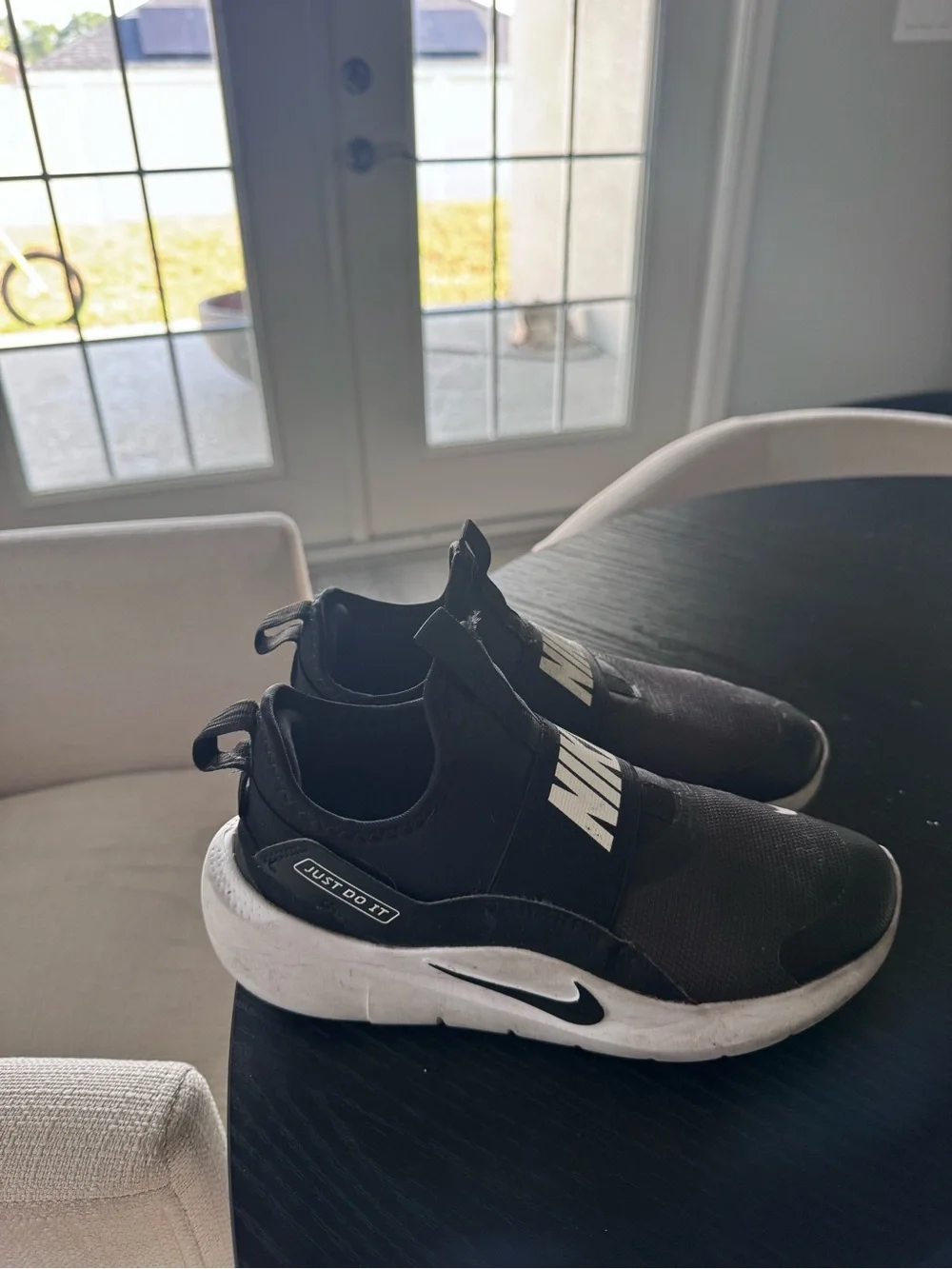 Nike Black Slip-On Sneakers with White Logo Accents
